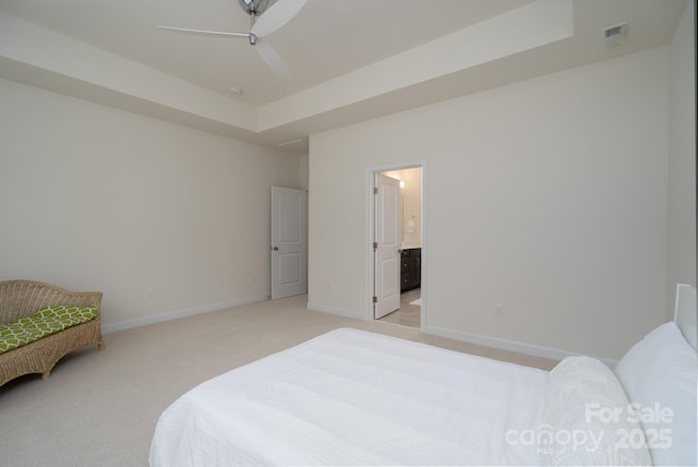 2407 Baxter Pl SE, Concord, NC 28025 - bedroom with light carpet, a raised ceiling, ensuite bath, and ceiling fan
