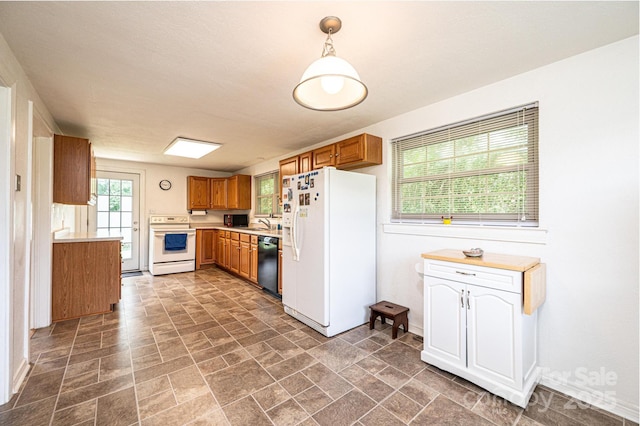 559 15th Ave SE, Hickory, NC 28602 - kitchen featuring white appliances, light countertops, stone finish flooring, brown cabinetry, and pendant lighting