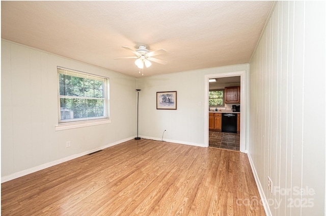 559 15th Ave SE, Hickory, NC 28602 - spare room with light wood finished floors, a ceiling fan, and plenty of natural light