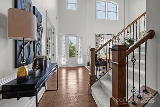 16522 Flintrock Falls Ln, Charlotte, NC 28278 - entrance foyer featuring stairs, a high ceiling, wood finished floors, and a wainscoted wall
