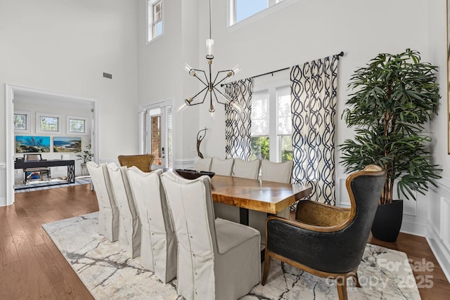 16522 Flintrock Falls Ln, Charlotte, NC 28278 - dining room with wood finished floors, a towering ceiling, and a chandelier