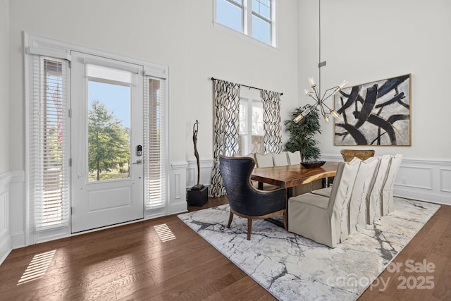 16522 Flintrock Falls Ln, Charlotte, NC 28278 - dining room with a decorative wall, wainscoting, wood finished floors, and a towering ceiling