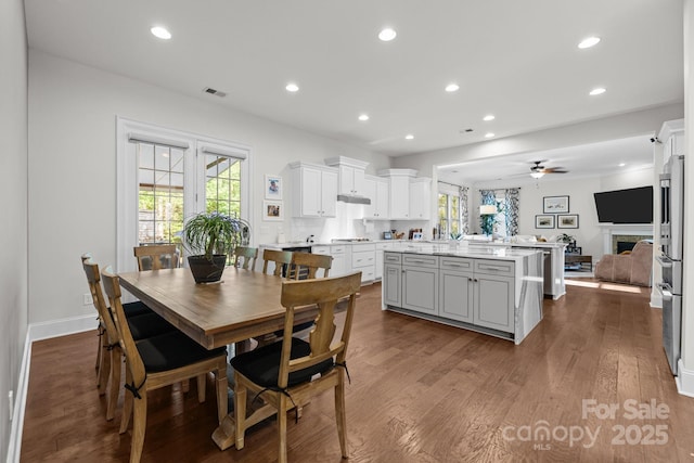 16522 Flintrock Falls Ln, Charlotte, NC 28278 - dining room with ceiling fan, recessed lighting, plenty of natural light, dark wood-style flooring, and a fireplace