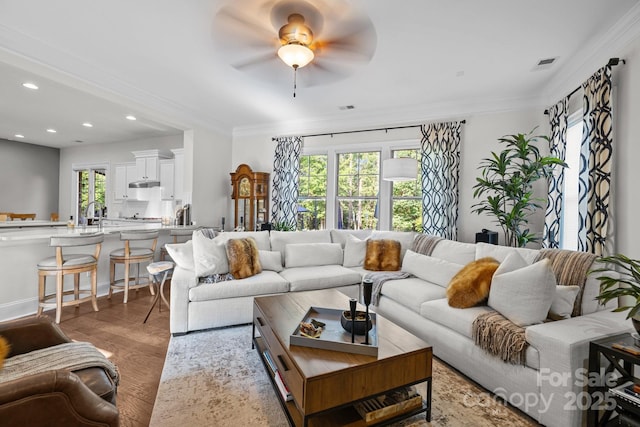 16522 Flintrock Falls Ln, Charlotte, NC 28278 - living room featuring a ceiling fan, light wood-style flooring, ornamental molding, and recessed lighting
