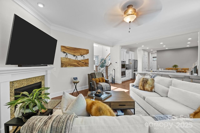16522 Flintrock Falls Ln, Charlotte, NC 28278 - living area with a ceiling fan, recessed lighting, light wood-type flooring, a premium fireplace, and ornamental molding
