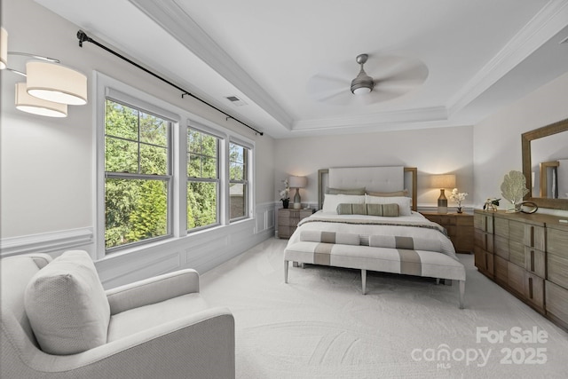 16522 Flintrock Falls Ln, Charlotte, NC 28278 - bedroom featuring a tray ceiling, wainscoting, light colored carpet, ornamental molding, and ceiling fan