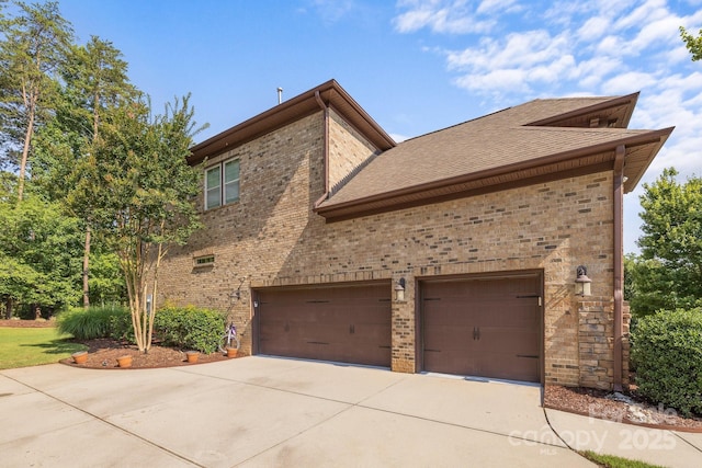 16522 Flintrock Falls Ln, Charlotte, NC 28278 - view of home's exterior featuring brick siding, concrete driveway, a shingled roof, and a garage