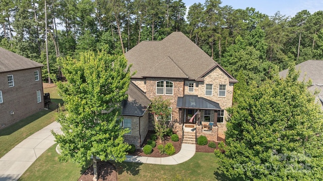 16522 Flintrock Falls Ln, Charlotte, NC 28278 - view of front facade with a front lawn, a shingled roof, stone siding, and brick siding