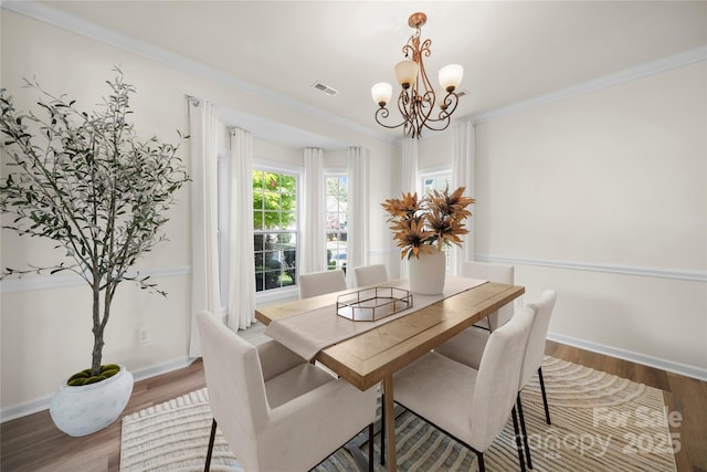 14801 Provence Ln, Charlotte, NC 28277 - dining area featuring a chandelier, wood finished floors, and ornamental molding