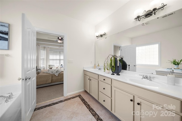 14801 Provence Ln, Charlotte, NC 28277 - bathroom with double vanity, connected bathroom, a bath, tile patterned flooring, and ceiling fan