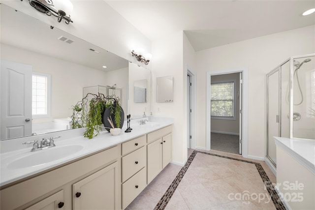 14801 Provence Ln, Charlotte, NC 28277 - bathroom featuring double vanity, a stall shower, and healthy amount of natural light