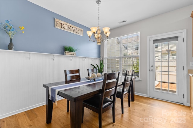 514 Bent Leaf Ct, Fort Mill, SC 29708 - dining area featuring a chandelier, light wood-style flooring, and wainscoting