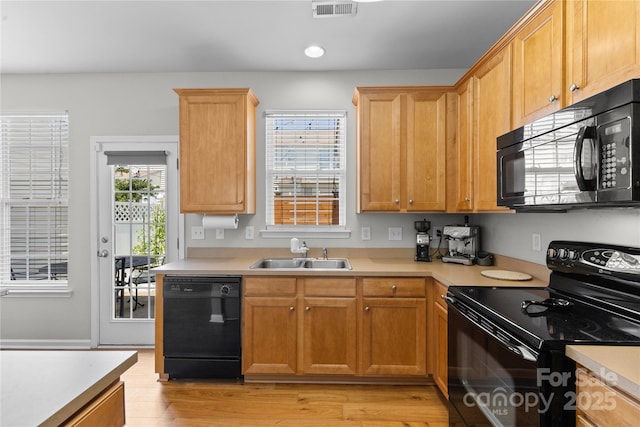 514 Bent Leaf Ct, Fort Mill, SC 29708 - kitchen with black appliances, light countertops, light wood finished floors, and recessed lighting