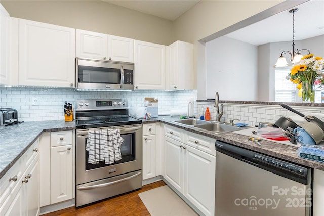 11521 Savannah Creek Dr, Charlotte, NC 28273 - kitchen featuring stainless steel appliances, white cabinets, dark wood finished floors, and tasteful backsplash
