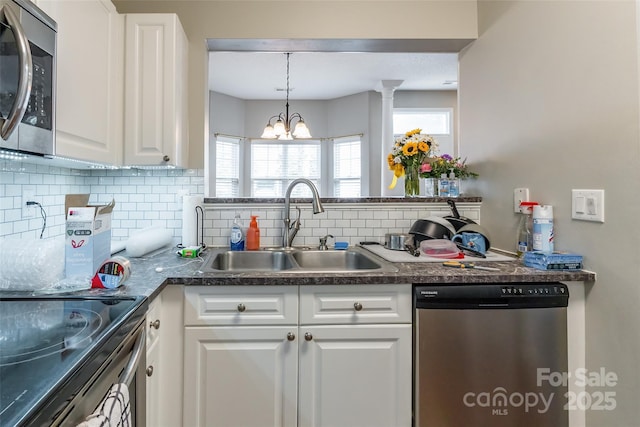 11521 Savannah Creek Dr, Charlotte, NC 28273 - kitchen with stainless steel appliances, tasteful backsplash, white cabinetry, and a chandelier