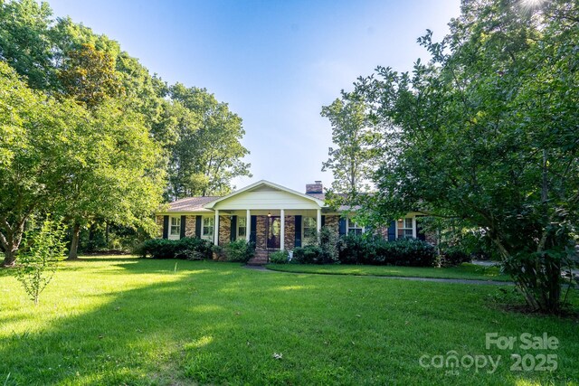 402 Scotland Dr, Kings Mountain, NC 28086 - view of front facade featuring a front lawn, a chimney, and brick siding