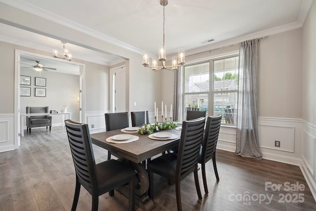 10437 Paper Birch Dr, Charlotte, NC 28215 - dining room with a chandelier, ceiling fan, wood finished floors, wainscoting, and crown molding