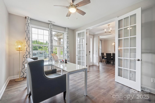 10437 Paper Birch Dr, Charlotte, NC 28215 - office area featuring a chandelier, french doors, wood finished floors, a ceiling fan, and ornamental molding