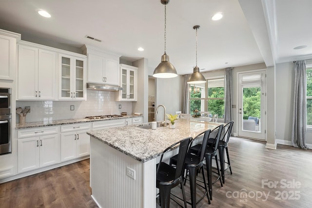 10437 Paper Birch Dr, Charlotte, NC 28215 - kitchen with plenty of natural light, decorative backsplash, dark wood finished floors, white cabinets, and recessed lighting
