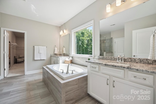 10437 Paper Birch Dr, Charlotte, NC 28215 - bathroom featuring two vanities, a stall shower, and a bath