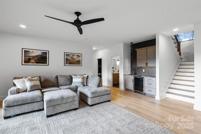55 Steeplebush Ct Unit 629, Tuckasegee, NC 28783 - living area featuring beverage cooler, light wood finished floors, stairs, wet bar, and recessed lighting
