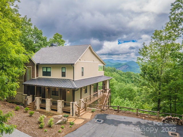 55 Steeplebush Ct Unit 629, Tuckasegee, NC 28783 - view of front facade featuring a porch, a standing seam roof, roof with shingles, a metal roof, and a mountain view
