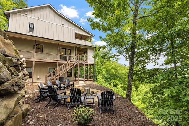 55 Steeplebush Ct Unit 629, Tuckasegee, NC 28783 - rear view of house with stairway, board and batten siding, and a fire pit