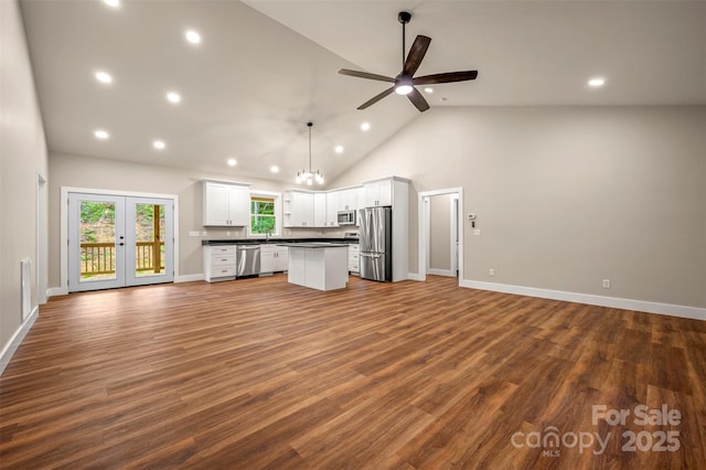 626 Felmet Rd, Flat Rock, NC 28731 - unfurnished living room with recessed lighting, a ceiling fan, french doors, dark wood finished floors, and high vaulted ceiling