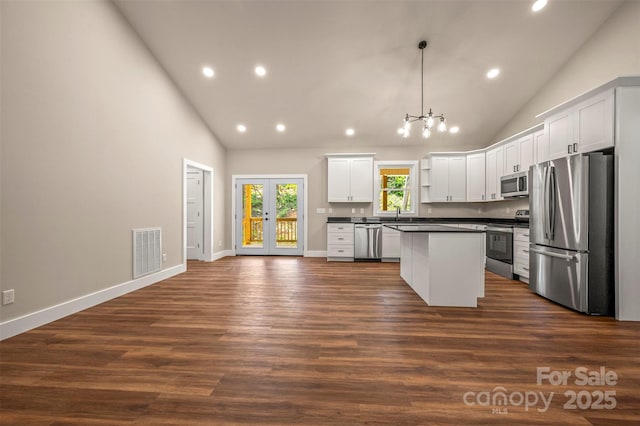 626 Felmet Rd, Flat Rock, NC 28731 - kitchen with stainless steel appliances, dark countertops, recessed lighting, high vaulted ceiling, and a center island