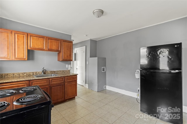 921 N Jackson St, Salisbury, NC 28144 - kitchen featuring black appliances, brown cabinetry, light stone countertops, and light tile patterned flooring