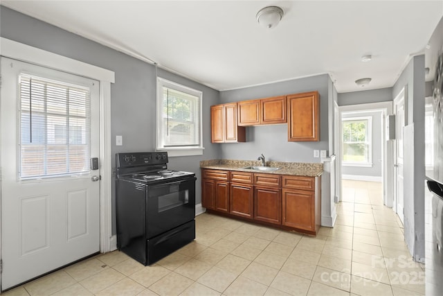 921 N Jackson St, Salisbury, NC 28144 - kitchen featuring black electric range oven, healthy amount of natural light, and light tile patterned flooring