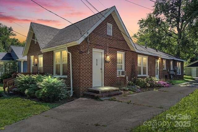 921 N Jackson St, Salisbury, NC 28144 - view of front facade featuring brick siding, a shingled roof, and cooling unit