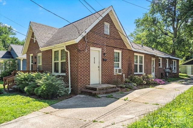 921 N Jackson St, Salisbury, NC 28144 - view of front of home featuring brick siding, a shingled roof, and cooling unit