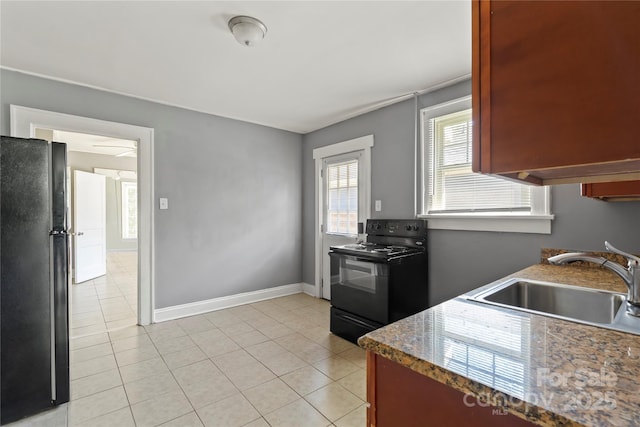 921 N Jackson St, Salisbury, NC 28144 - kitchen with black appliances and light tile patterned floors