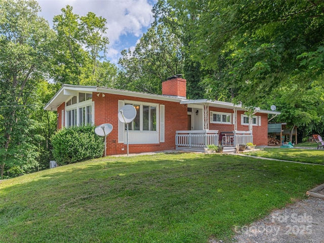 90 Hemlock Hill Hts, Canton, NC 28716 - ranch-style house with brick siding, a chimney, covered porch, and a front lawn