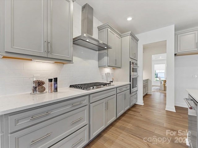 1516 Respect St NW, Concord, NC 28027 - kitchen featuring wall chimney exhaust hood, gray cabinetry, stainless steel appliances, light wood-type flooring, and recessed lighting