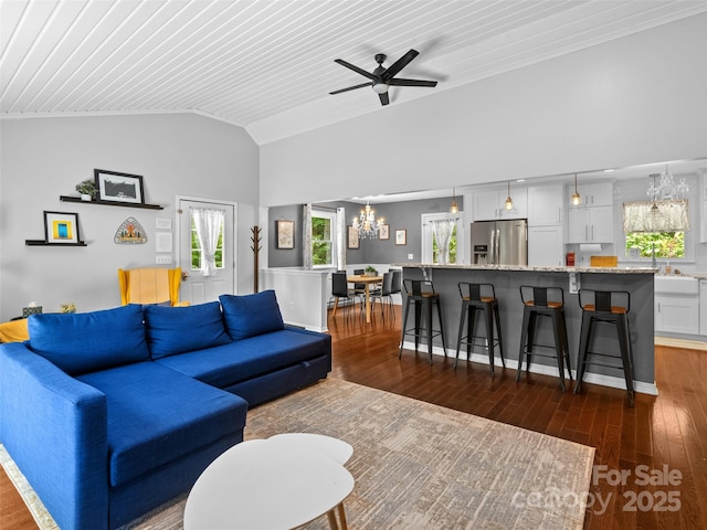 220 Deer Run Rd, Canton, NC 28716 - living room featuring a chandelier, vaulted ceiling, dark wood-style flooring, a ceiling fan, and ornamental molding