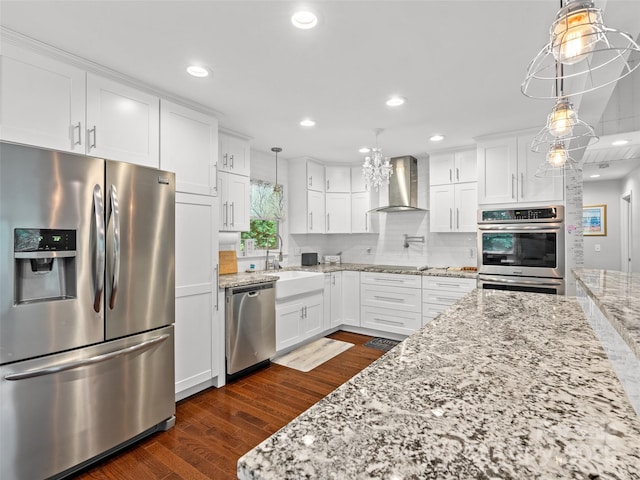 220 Deer Run Rd, Canton, NC 28716 - kitchen with appliances with stainless steel finishes, wall chimney range hood, white cabinetry, pendant lighting, and light stone counters
