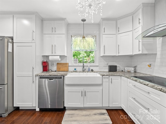 220 Deer Run Rd, Canton, NC 28716 - kitchen with appliances with stainless steel finishes, wall chimney exhaust hood, a chandelier, white cabinets, and decorative backsplash