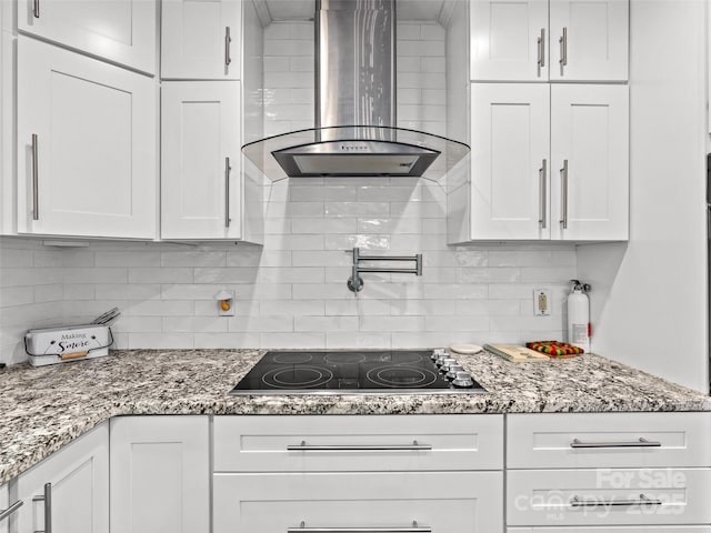 220 Deer Run Rd, Canton, NC 28716 - kitchen featuring wall chimney exhaust hood, black electric cooktop, tasteful backsplash, and white cabinetry