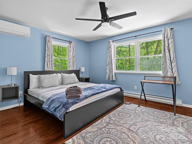 220 Deer Run Rd, Canton, NC 28716 - bedroom featuring a wall mounted AC, baseboard heating, wood finished floors, and ceiling fan