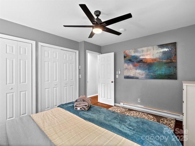 220 Deer Run Rd, Canton, NC 28716 - bedroom with baseboard heating, two closets, wood finished floors, and a ceiling fan