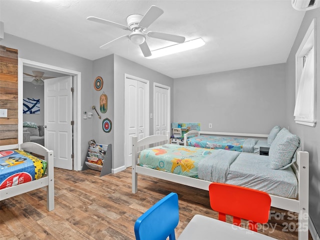 220 Deer Run Rd, Canton, NC 28716 - bedroom featuring multiple closets, wood finished floors, and a ceiling fan