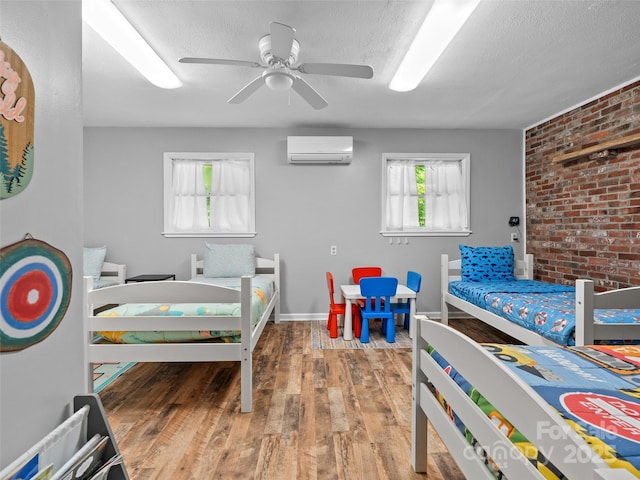 220 Deer Run Rd, Canton, NC 28716 - bedroom with a wall unit AC, wood finished floors, brick wall, a textured ceiling, and a ceiling fan