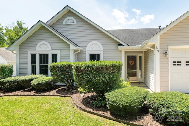 802 Woodlark Ct, Fletcher, NC 28732 - ranch-style home featuring a garage, roof with shingles, and a front lawn