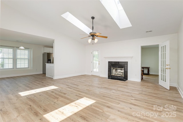 802 Woodlark Ct, Fletcher, NC 28732 - unfurnished living room with a skylight, light wood finished floors, a fireplace, and high vaulted ceiling