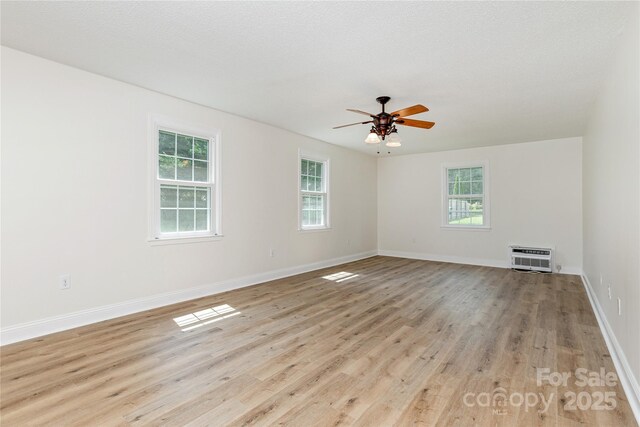 802 Woodlark Ct, Fletcher, NC 28732 - empty room featuring ceiling fan, light wood finished floors, and a wall mounted air conditioner