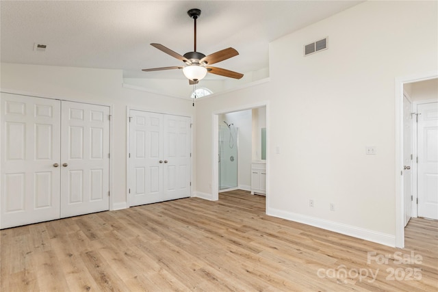 802 Woodlark Ct, Fletcher, NC 28732 - unfurnished bedroom with two closets, light wood-style floors, and a ceiling fan