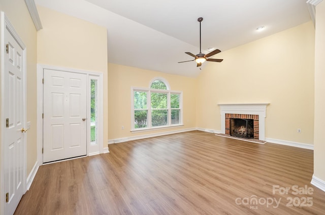 975 Pine Knoll Rd, Fort Mill, SC 29715 - unfurnished living room featuring wood finished floors, ceiling fan, a fireplace, and high vaulted ceiling