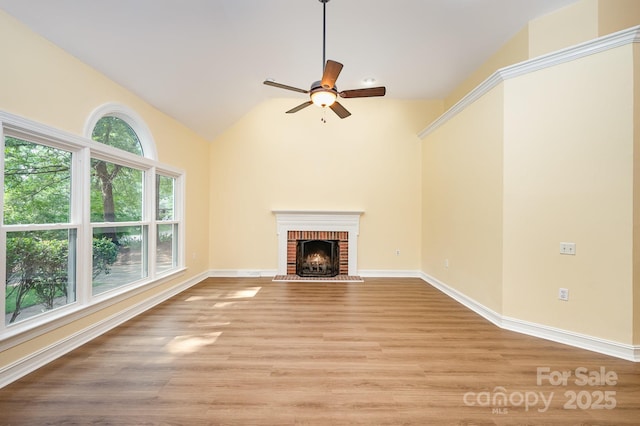 975 Pine Knoll Rd, Fort Mill, SC 29715 - unfurnished living room with a ceiling fan, light wood-style floors, a brick fireplace, and vaulted ceiling